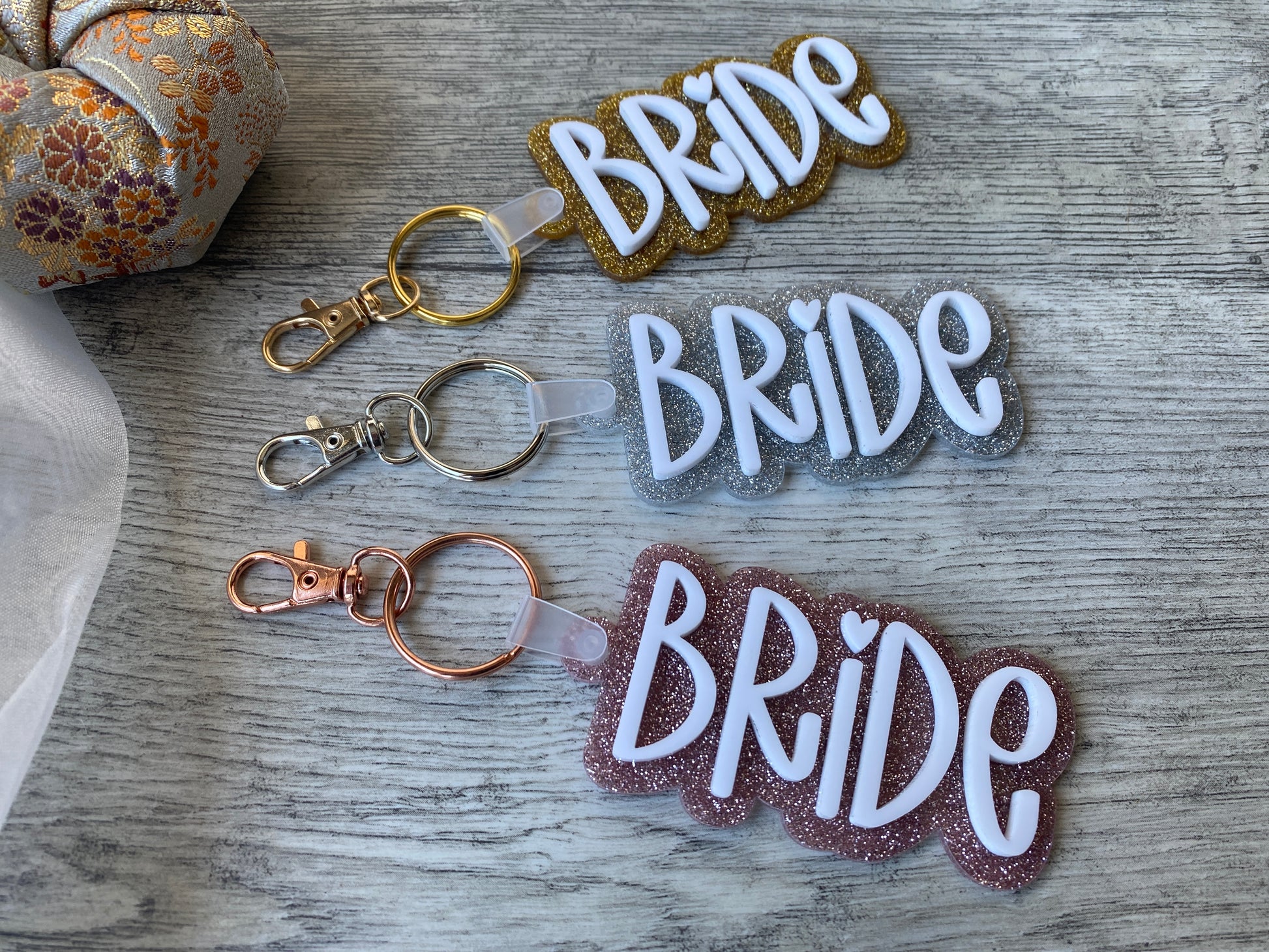 Fun bridal keychain with two layers of acrylic and shiny gold, silver, or pink backing.