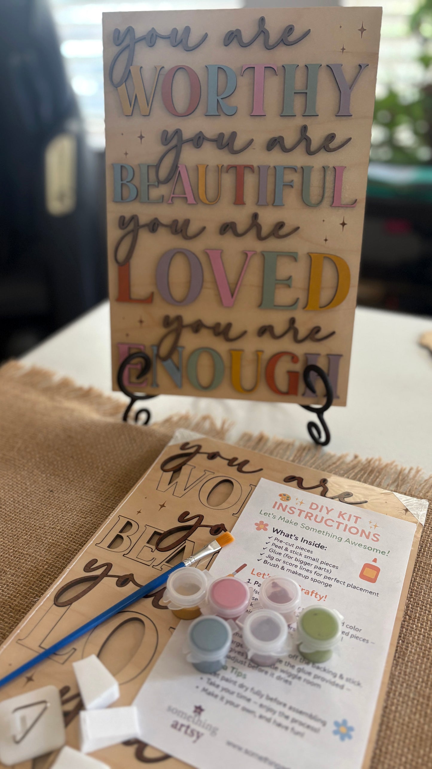 Painted DIY Inspirational Frame Kit and a packaged version with DIY instructions and materials below it.