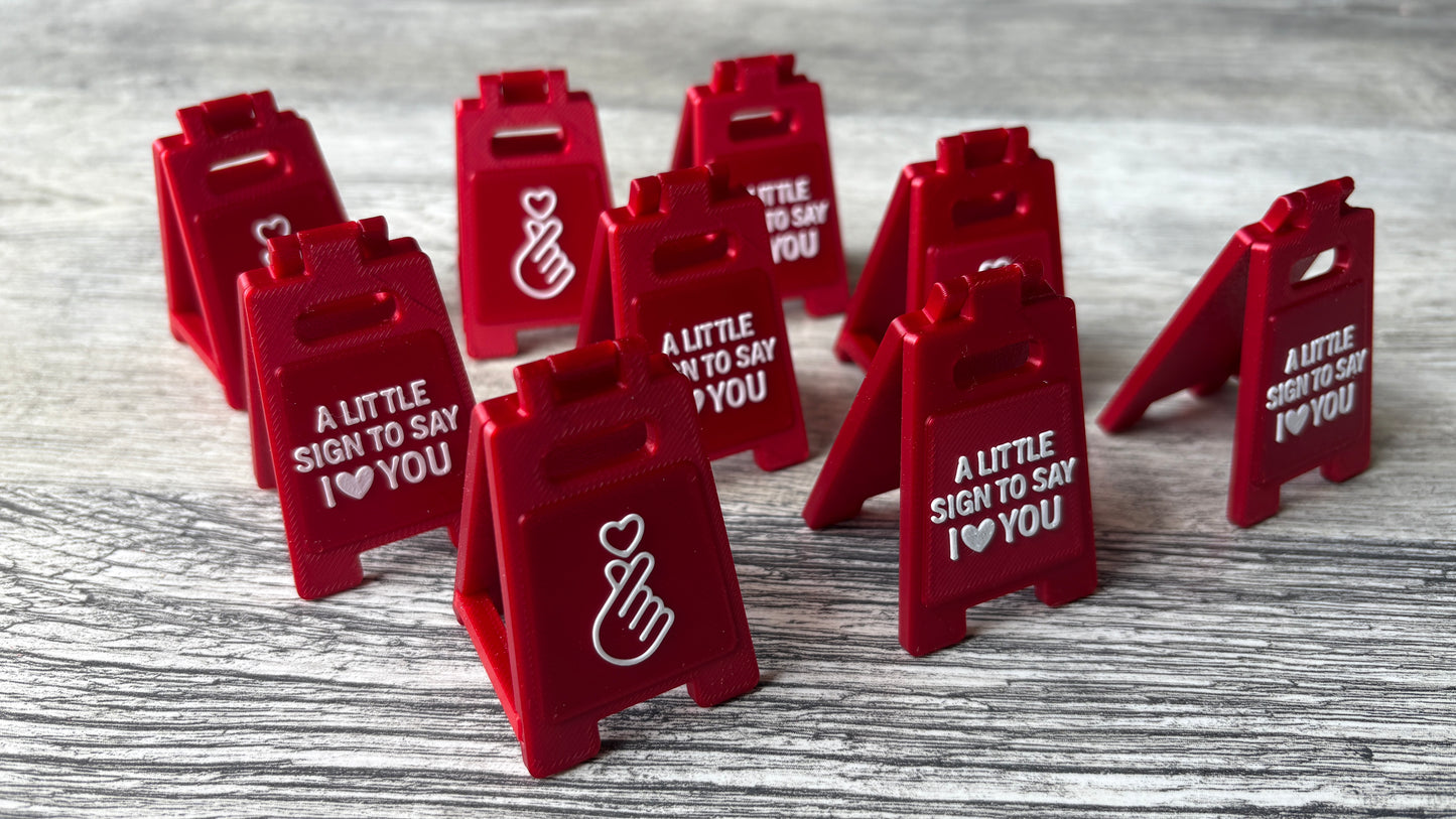 3D-printed mini sign with 'I love you' message & heart gesture with a removable support bar for easy storage