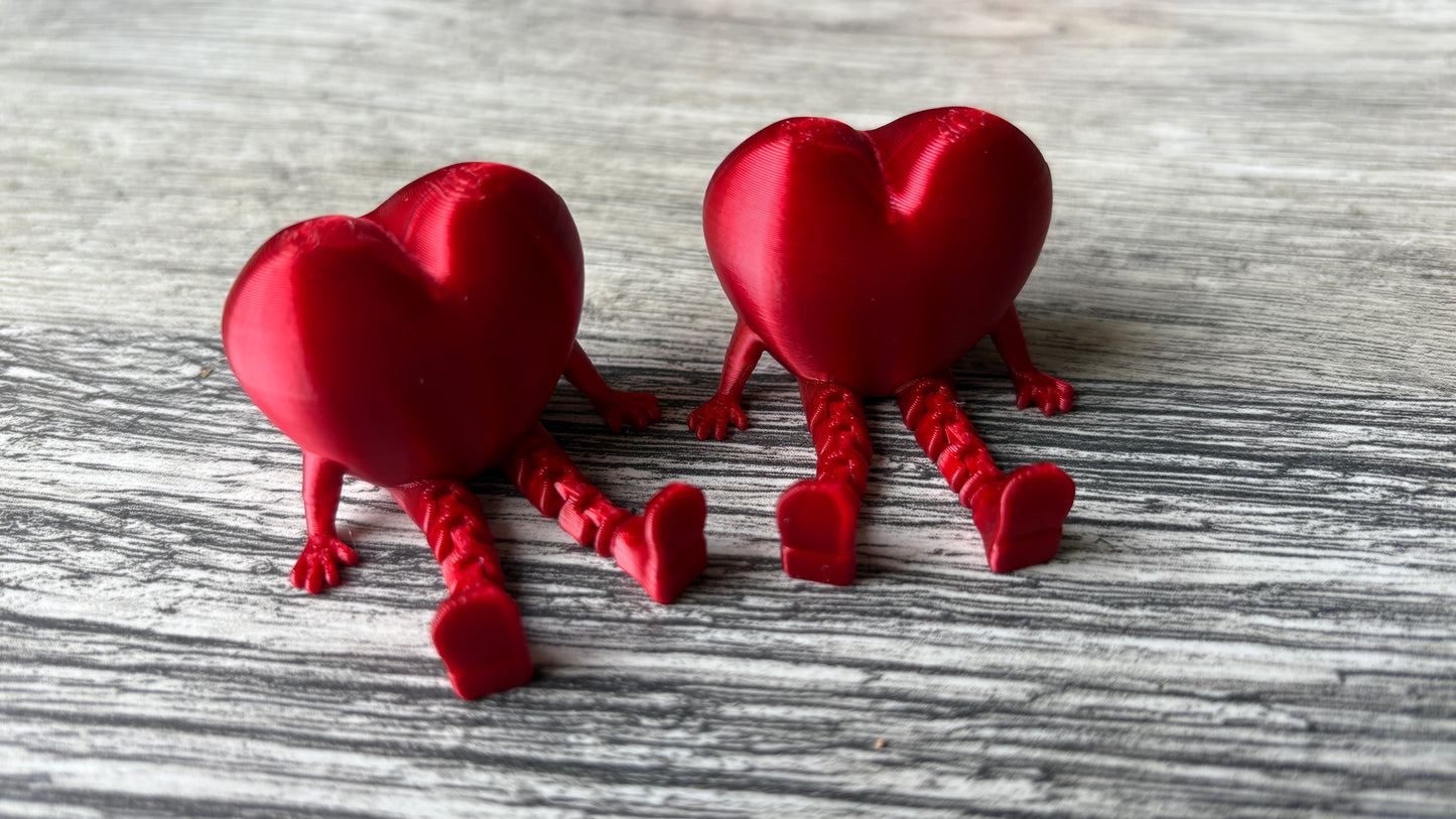 3D printed articulating heart figure sitting down.