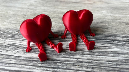 3D printed articulating heart figure sitting down.