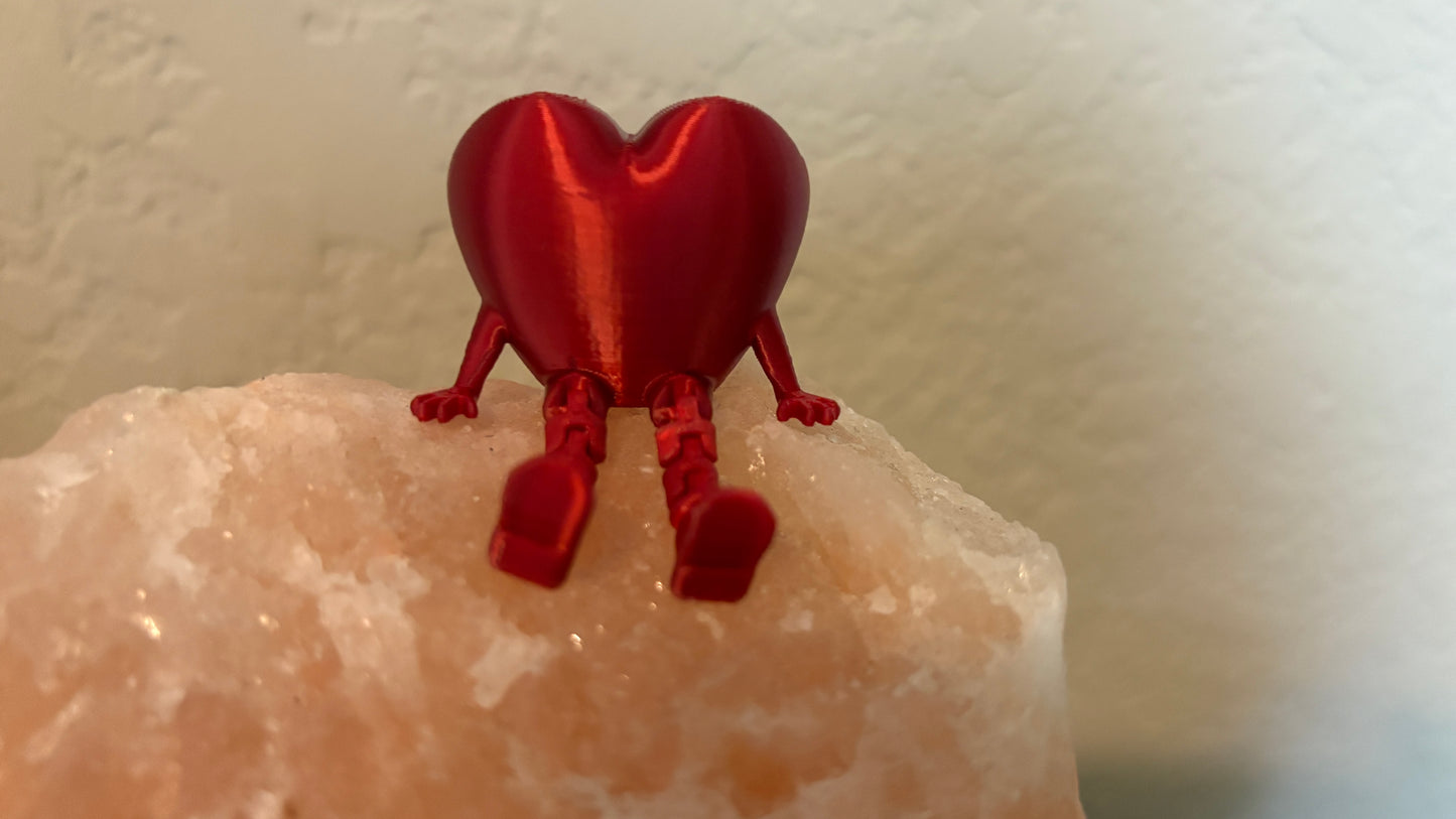 Front view of 3D printed articulating heart figure sitting on a salt rock.