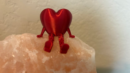 Front view of 3D printed articulating heart figure sitting on a salt rock.