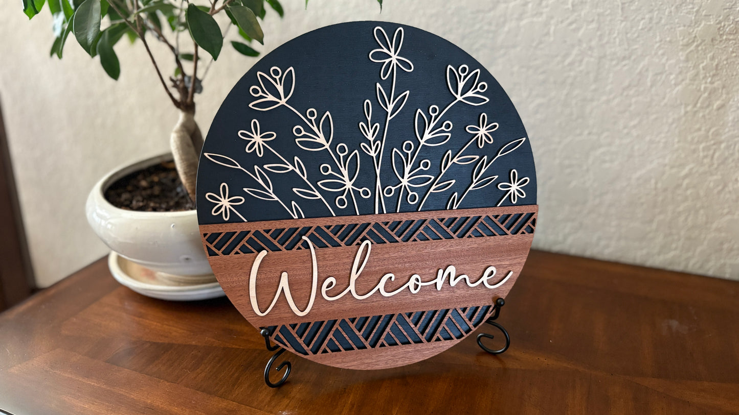 Wood welcome sign with elegant floral cutouts.