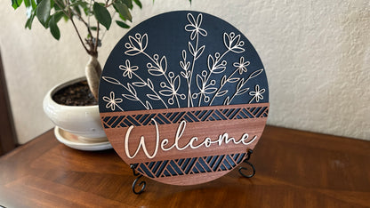 Wood welcome sign with elegant floral cutouts.