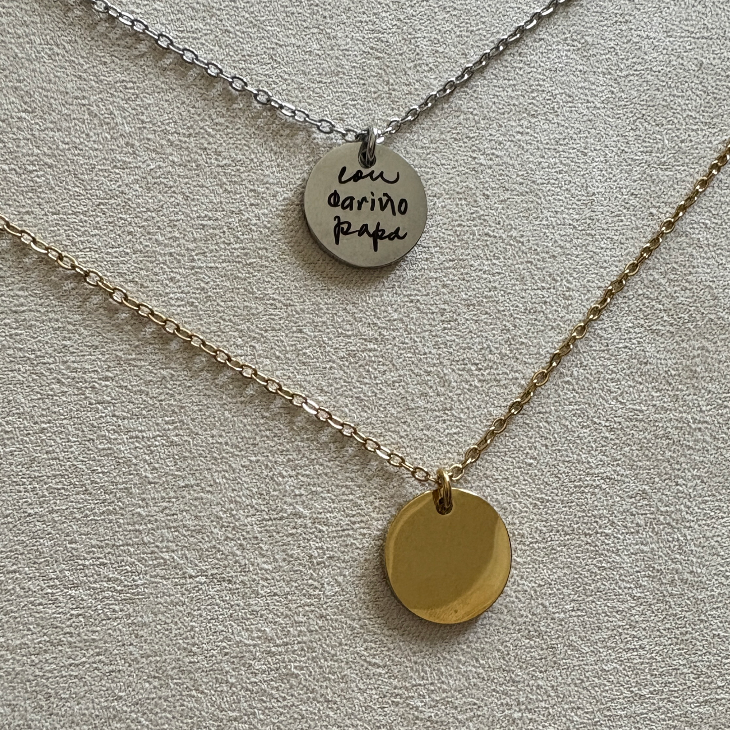 Silver and gold 15 mm disk necklaces. The silver has a custom handwritten note engraved from a loved one.