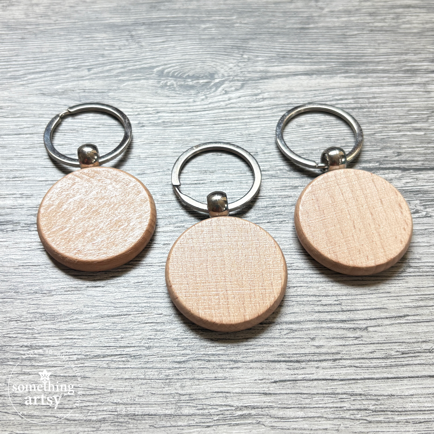 Back of the round natural wood keychain with stainless steel ring