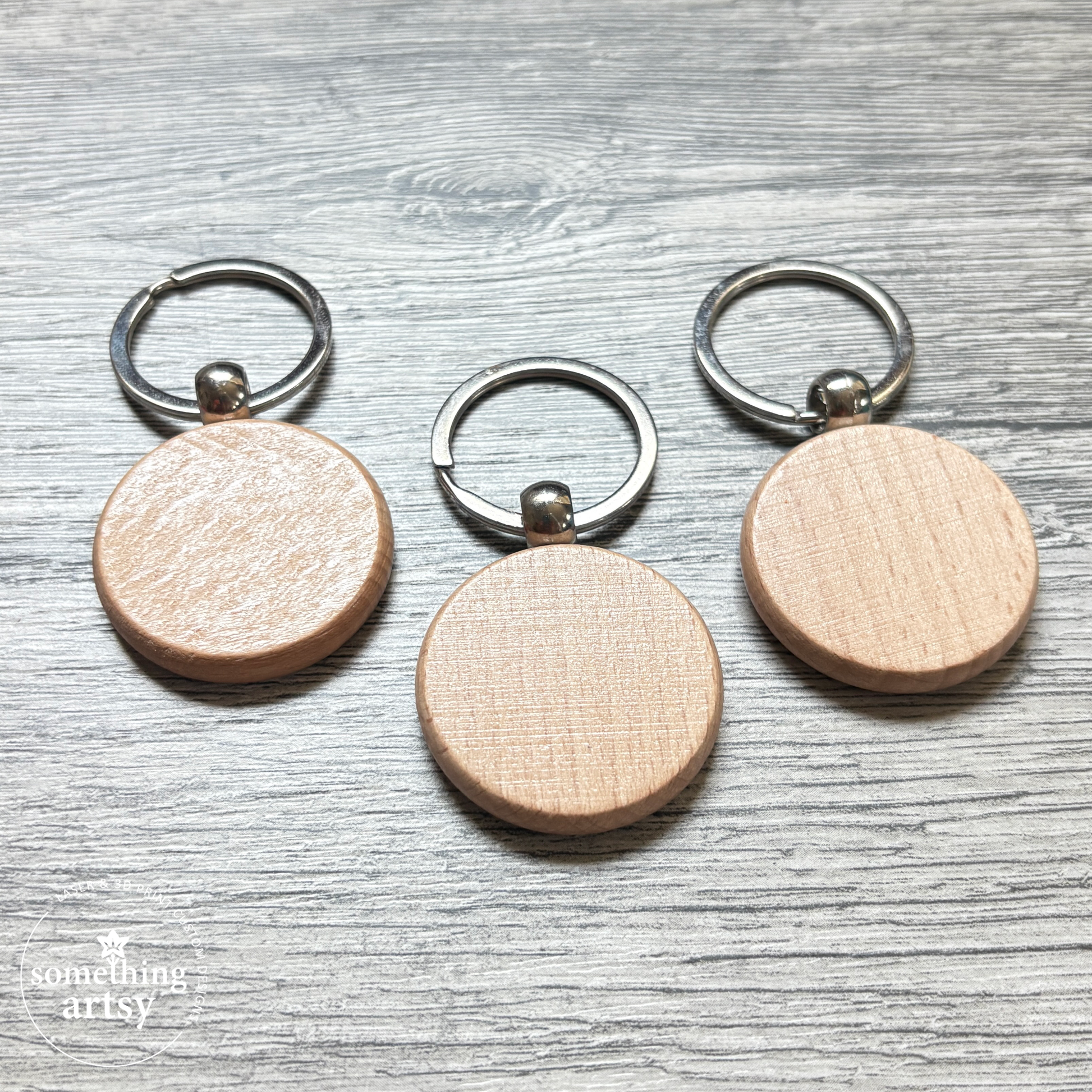 Back of the round natural wood keychain with stainless steel ring