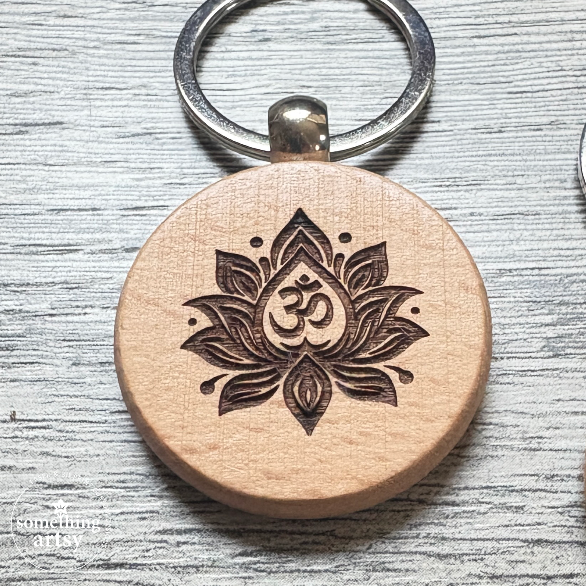 Close up of the engraved on a natural wood round keychain