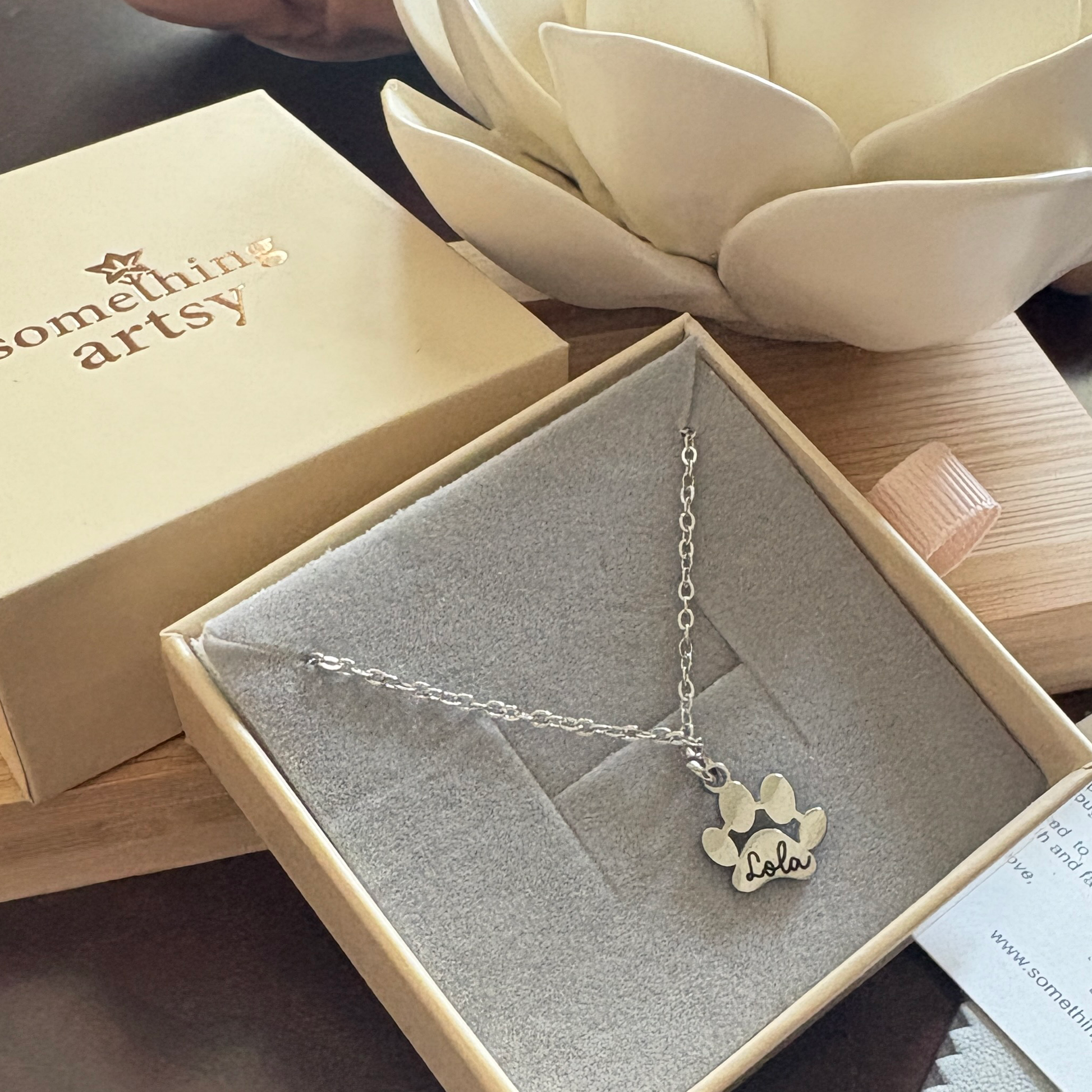 Silver paw necklace with custom name "Lola" engraved
