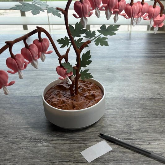 3D printed Bleeding Hearts plant with 14 heart-shaped flowers designed to hold rolled-up notes, featuring a hidden rotating jewelry box inside the pot.