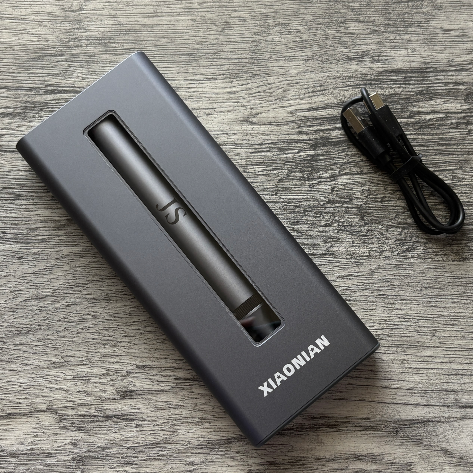 Front view of 52-in-1 Electric Screwdriver Set with the custom initials JS engraved on the screwdriver with cable next to it.