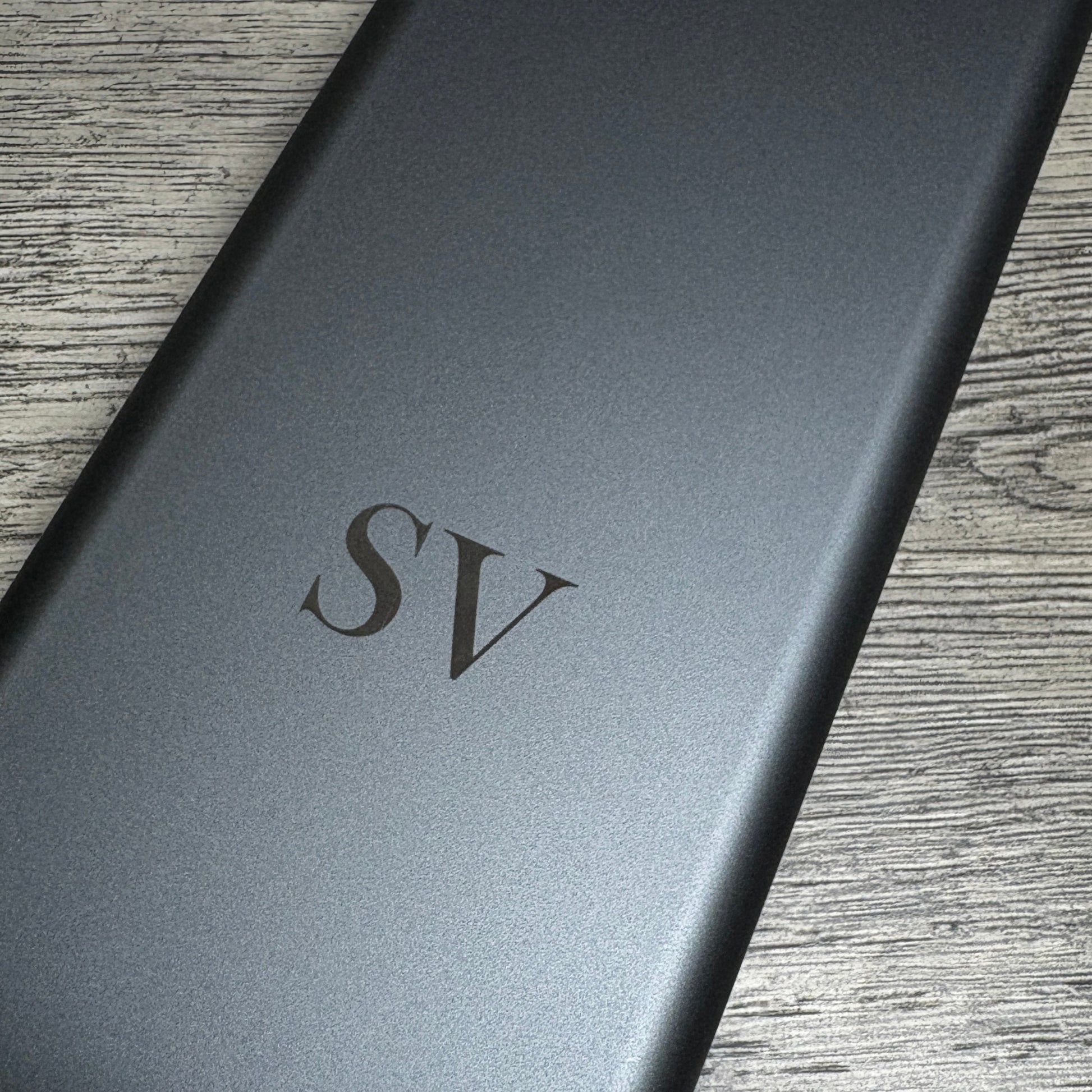 Close up of the metalic case of the electric screwdriver set with 'SV' initials 