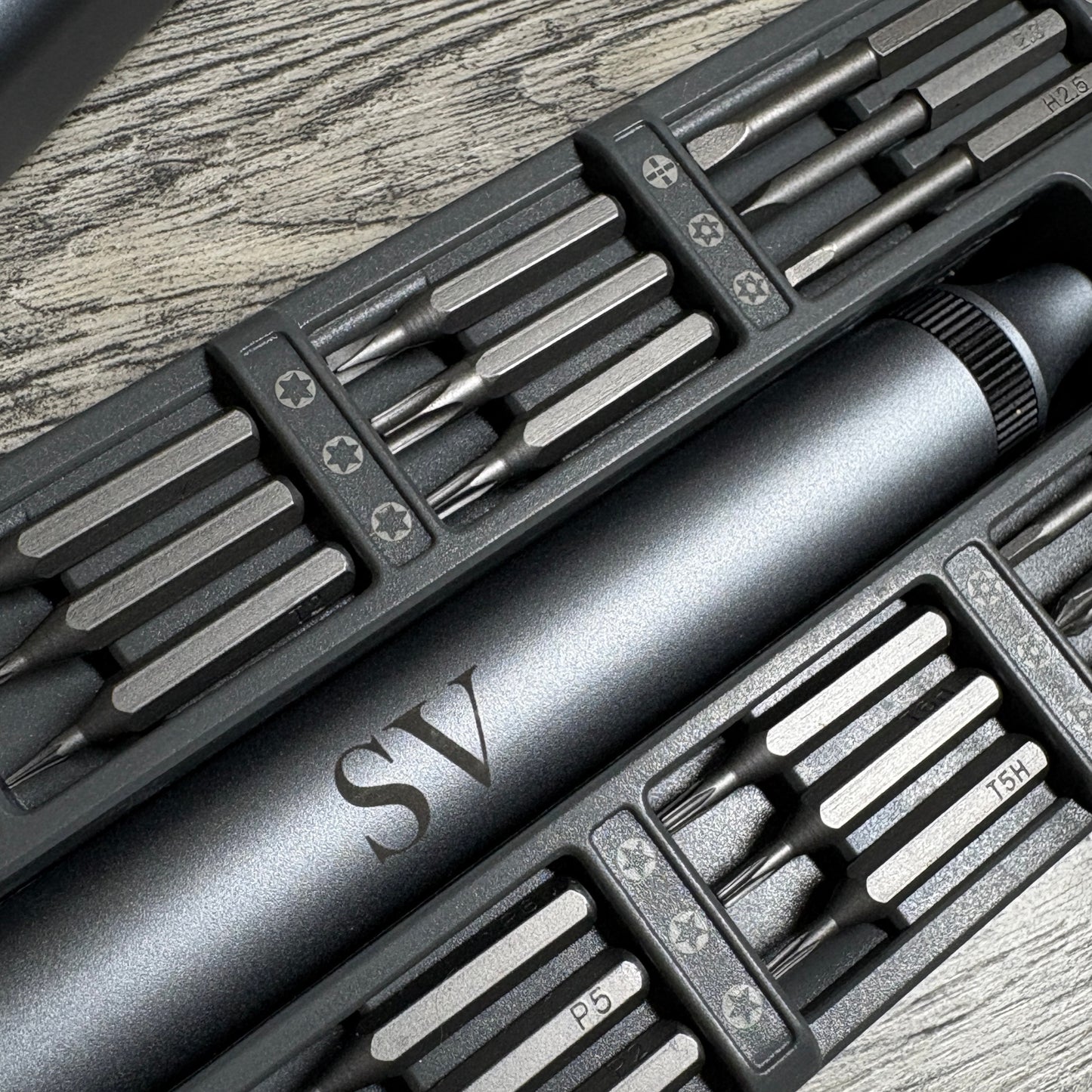 Set of screwdriver in a metalic case with the tool engraved
